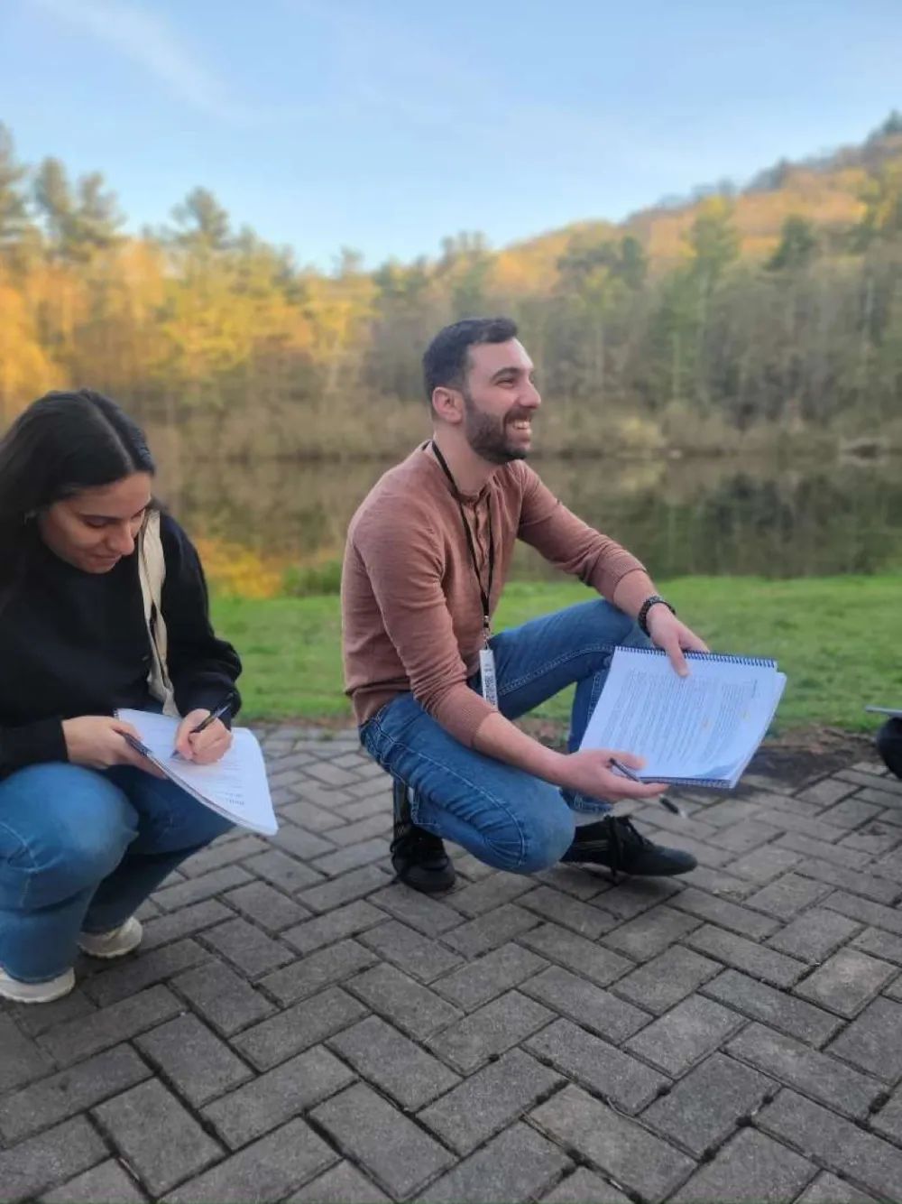 Andrew and a colleague reviewing notes outdoors